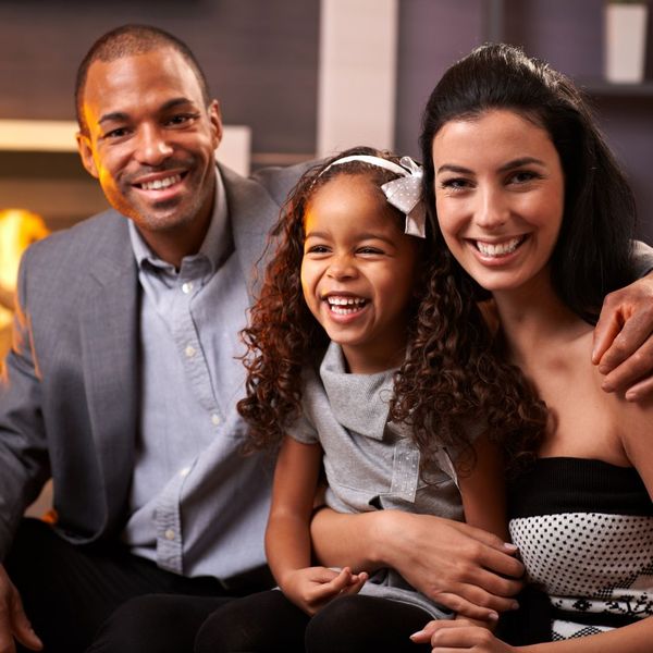 photo of a happy family sitting together on the couch